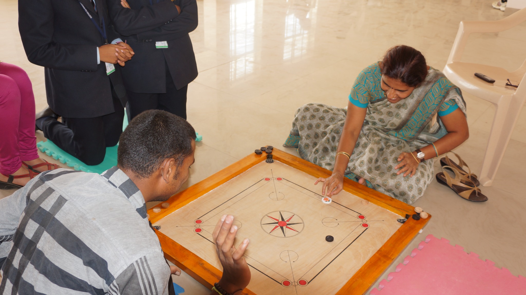 Students participating in a carrom match